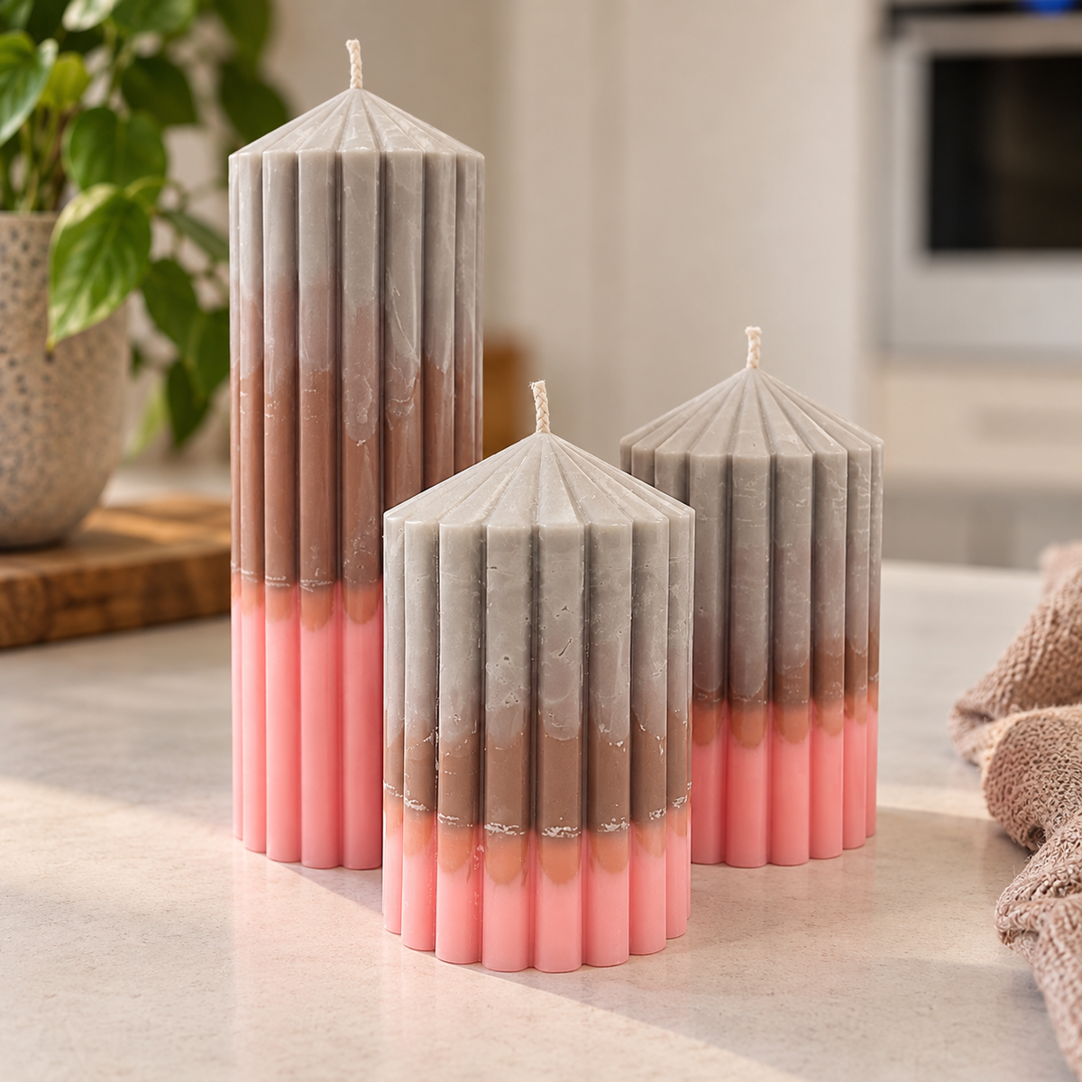 Håndlavede cylindriske sojalys i grå, brun og rosa